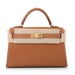 A brown Hermes Kelly 22 handbag with a gold hardware clasp and a beige canvas strap.