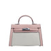 Pink handbag with a silver clasp on a light gray background
