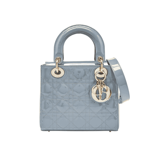 Dior Blue handbag with gold hardware on a white background
